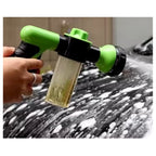 Close-up of the green 8-in-1 foam wash gun with soap dispenser in use