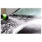 Close-up of the foam wash gun rinsing thick soap from a car